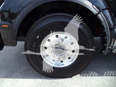 Kenworth T880 front wheel and fender showing wheel and tire details.
