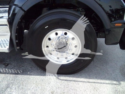 Kenworth T880 wheel and front fender showing polished aluminum front wheel with Toyota? No, it's a heavy truck wheel.