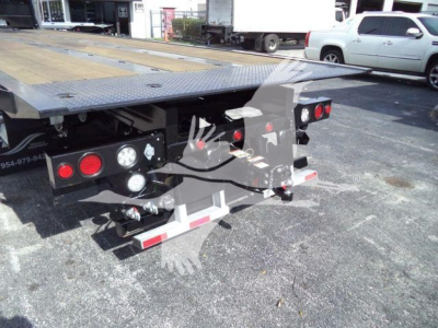 Kenworth T880 rollback bed rear view showing platform and rear light clusters with chrome bumper guards.