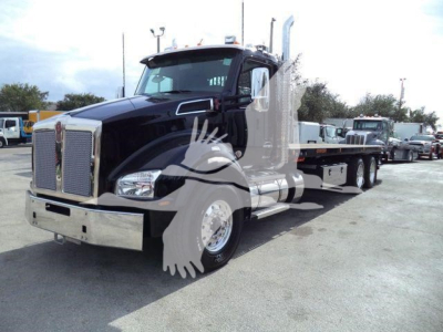 Kenworth T880 rollback truck showing front grille with chrome bumper and long wheelbase.