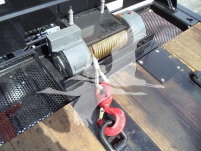Kenworth T880 rollback truck winch and cable drum with hook and metal deck, viewing from side with winch motor and synthetic line in the drum.