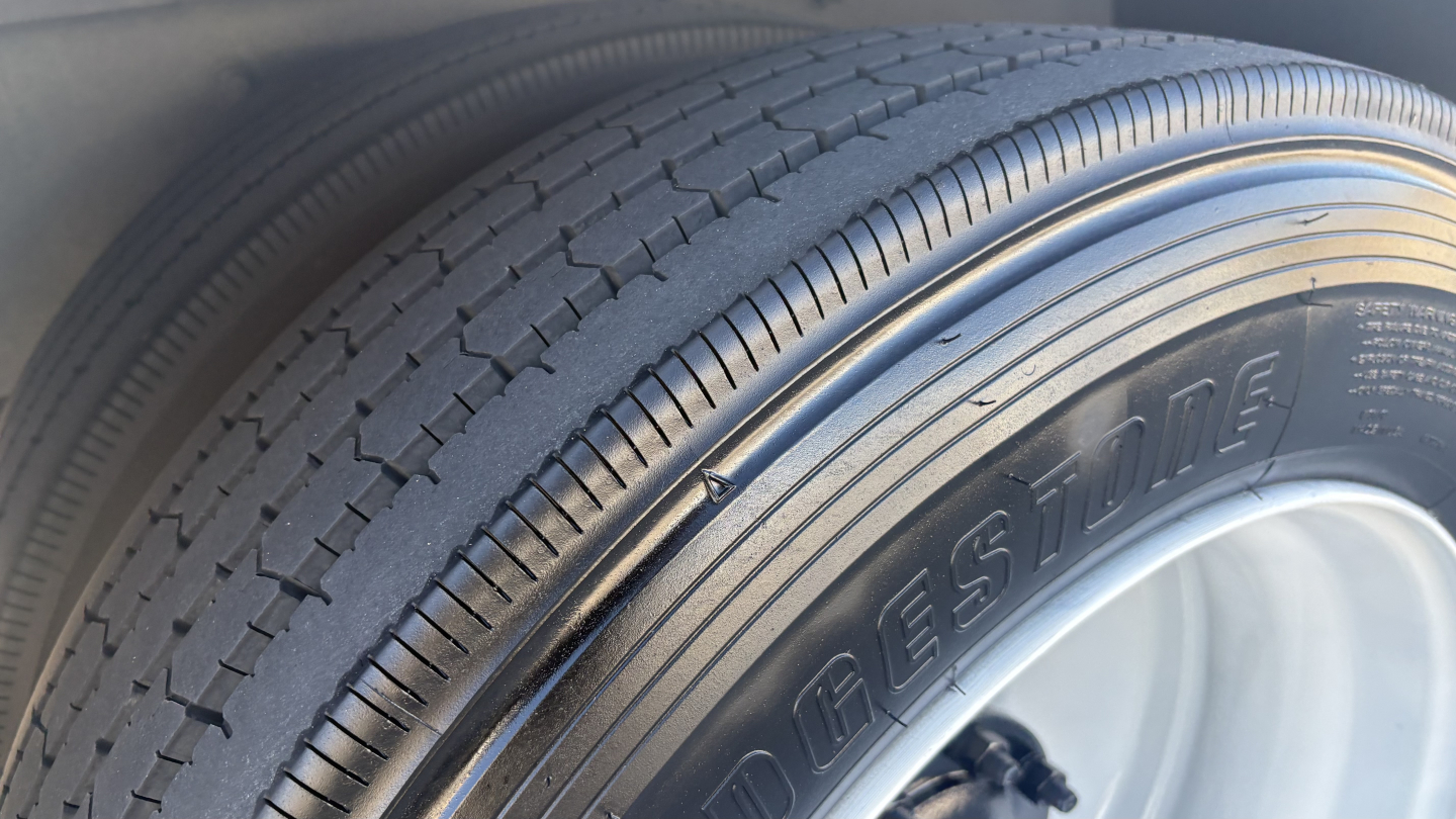 Bridgestone tire close-up on Freightliner M2-106 box truck wheel well.