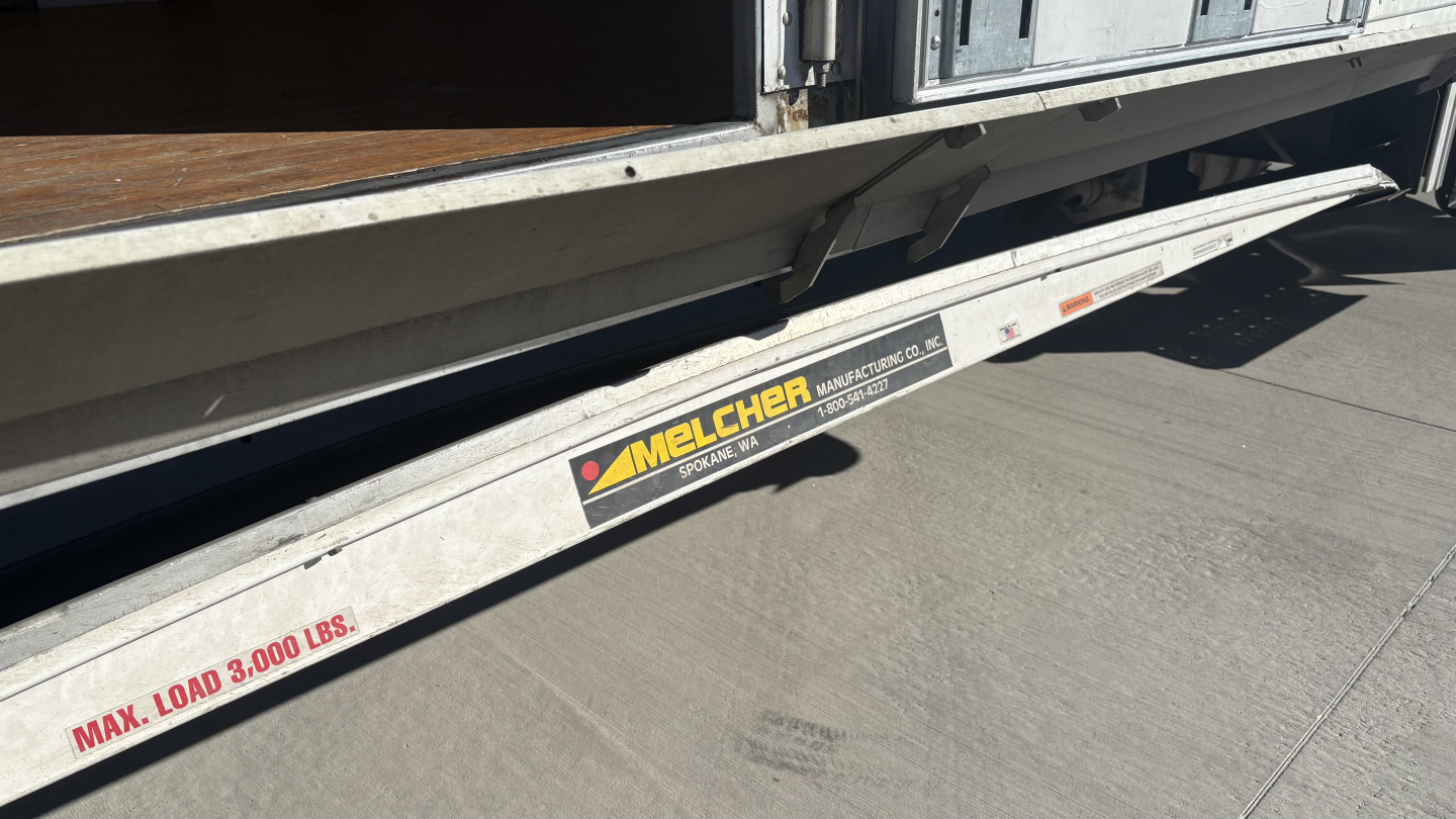 Freightliner M2-106 side slide with Melcher load max label 3000 lbs