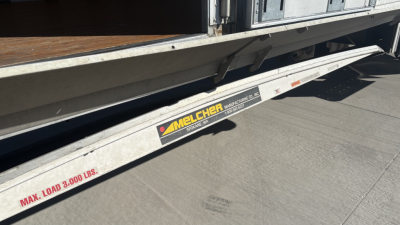 Freightliner M2-106 side slide with Melcher load max label 3000 lbs