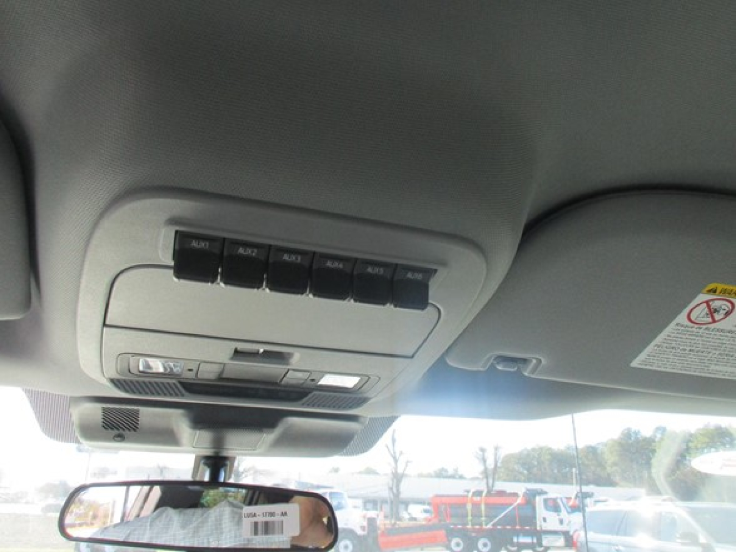 Ford F-350 cab and chassis interior overhead controls and sun visor along with rearview mirror.
