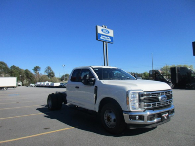 Ford F-350 cab and chassis truck in a dealership lot, white exterior, front grille visible