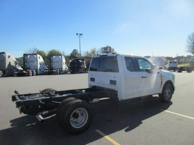 Ford F-Series cab and chassis in white showing chassis frame and rear axle with single rear wheel on the passenger side.