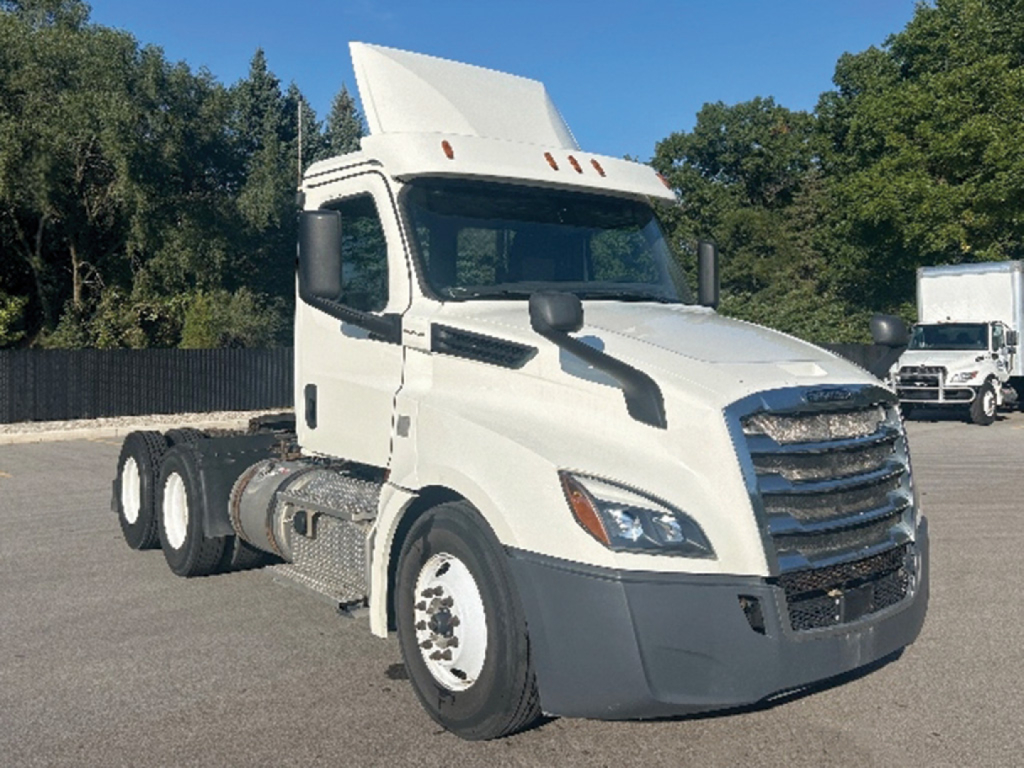 Freightliner Cascadia 126 daycab tractor trucks showing side and front view with white exterior and large grille.