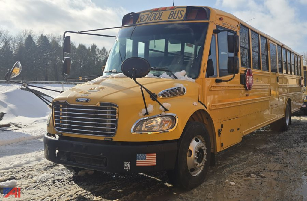 Front-left view of a yellow 2014 Freightliner B2 school bus with black bumper and dual mirrors.
