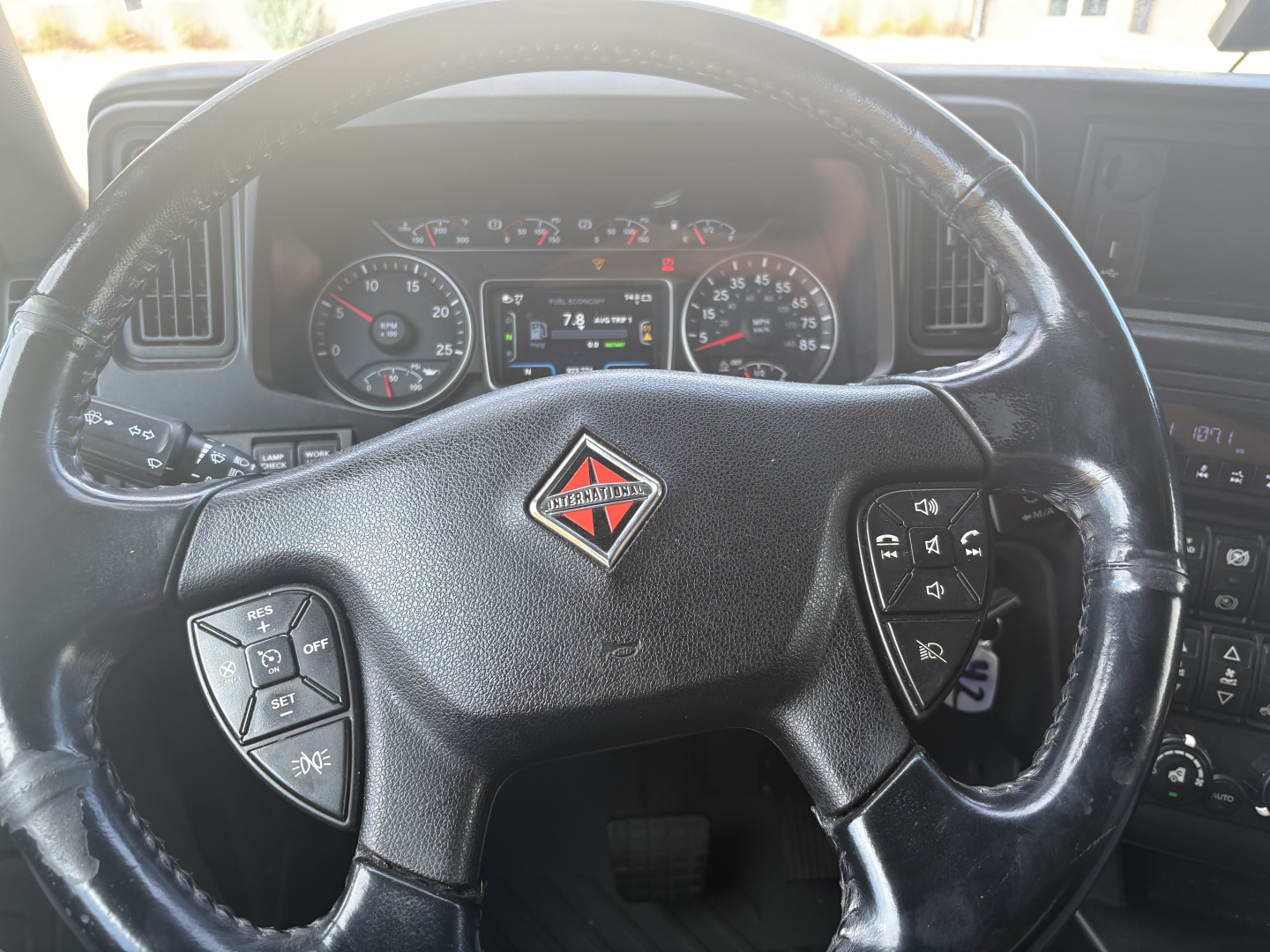 Steering wheel and dashboard of a 2023 International LT625 truck showing instrument cluster and controls.