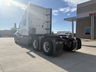Truck cab and dual rear axles of a 2023 International LT625 semi-truck in a dealership lot.