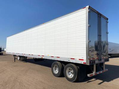 Trailer showing a white refrigerated semi-trailer with dual rear wheels and closed doors.