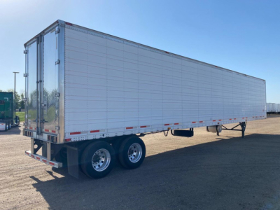 Trailer side view of a 2020 Wabash refrigerated trailer showing smooth aluminum panels and double rear doors.