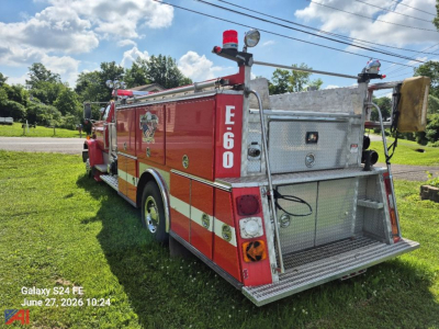 GMC Topkick 7000 pumper fire truck rear view with E-60 on side panel and equipment storage open