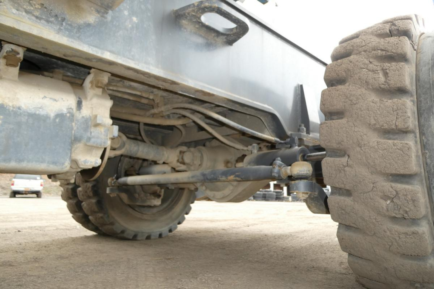 Terex MHL340D chassis with large off-road tires showing front axle and suspension components.