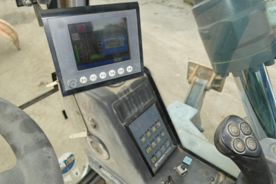 Terex MHL340D cab interior showing display screen and control panel with keypad and joysticks.