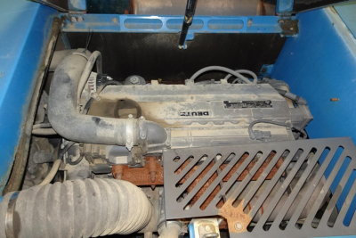 Terex MHL340D engine bay showing intake hose, diesel engine with label and surrounding blue framework.