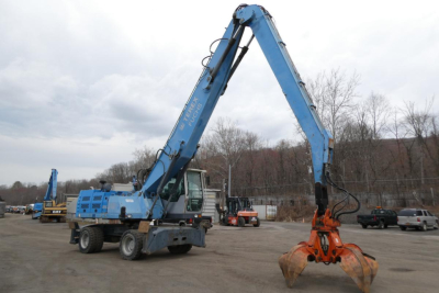 Terex MHL340D hydraulic material handler in blue, side view with long articulating boom and orange grapple at the end.