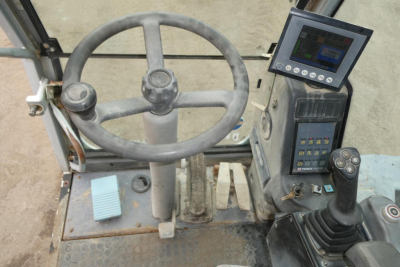 Terex MHL340D operator cab showing steering wheel, pedal controls, and digital display panel