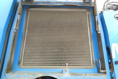 Radiator/grille area of a blue Terex MHL340D boom lift showing cooling radiator with protective frame and clamps.