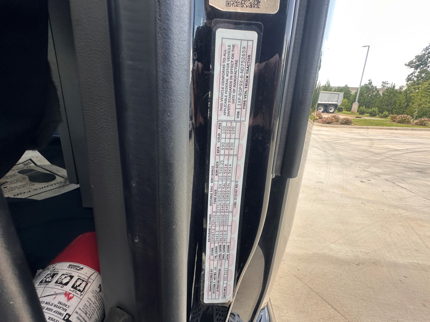 Peterbilt 579 cab door jamb label showing VIN and specifications in view.