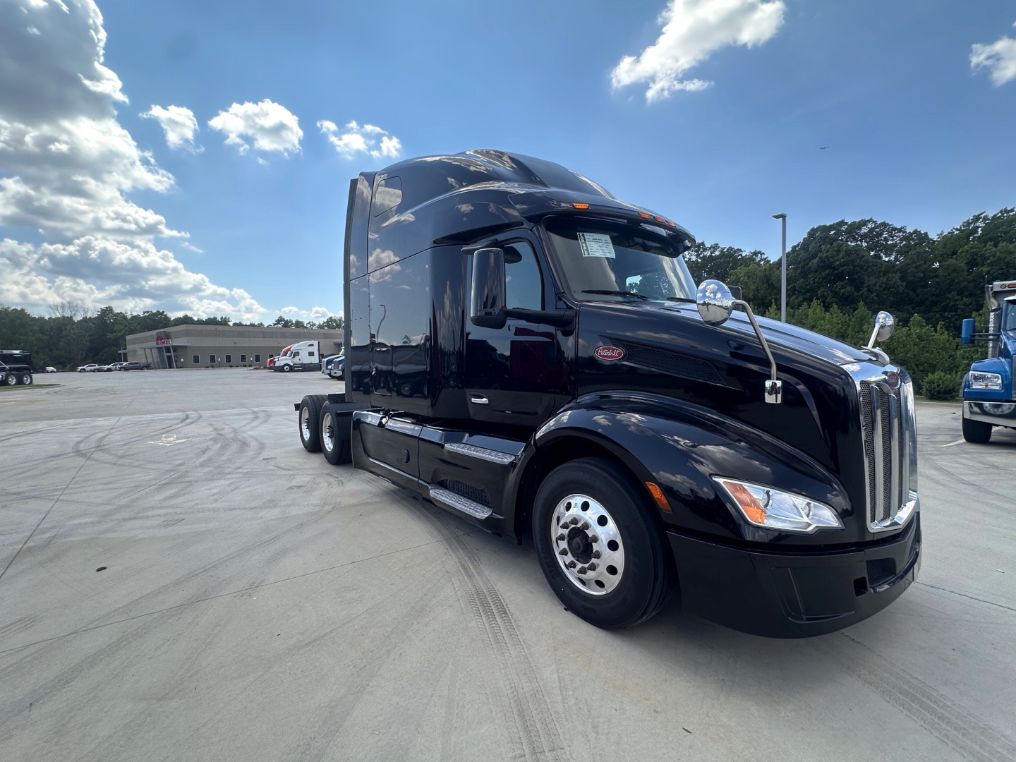 Peterbilt 579 tractor in black, side view showing cab, exhaust stack, and front bumper.