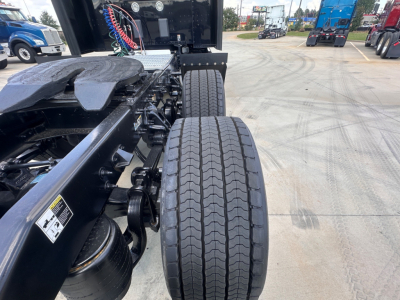 Peterbilt 579 chassis and dual rear wheels viewed from side showing wheels, suspension, and fuel/air lines.