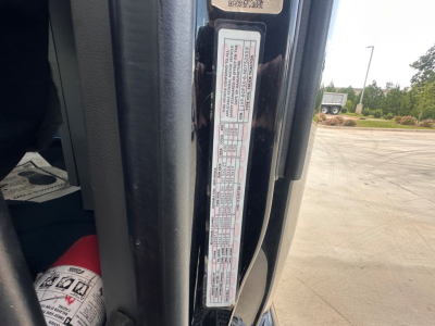 Peterbilt 579 cab door jamb label showing VIN and specifications in view.