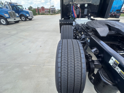 Peterbilt 579 tractor chassis and rear tires showing dual rear axles and frame with electrical harnesses and fifth-wheel area.