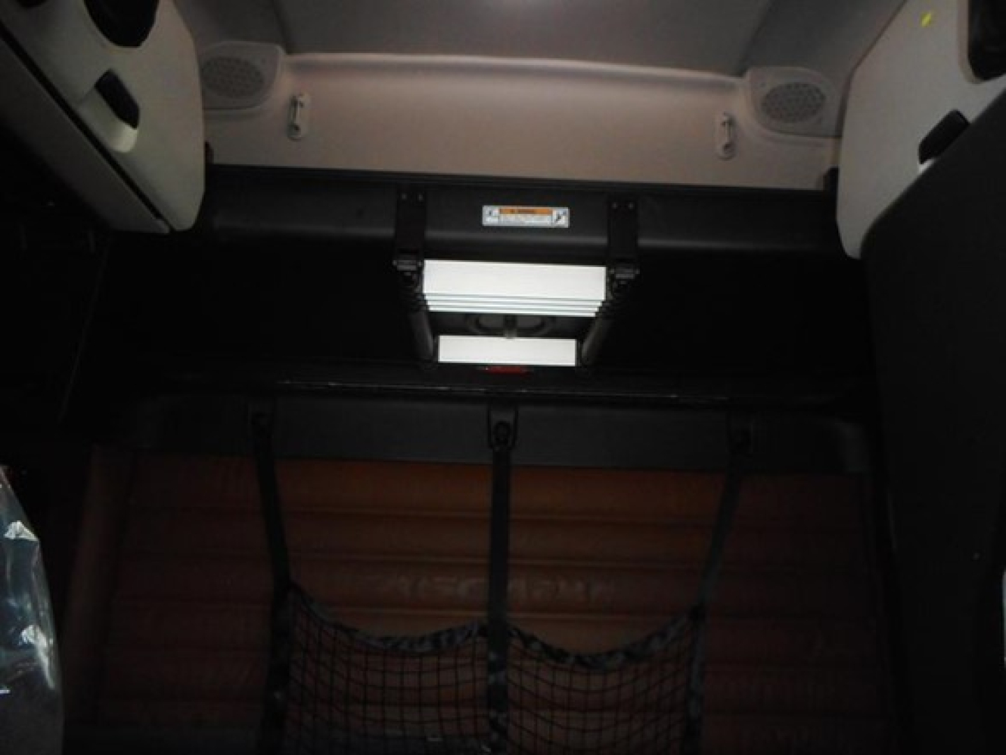 Freightliner Cascadia 126 cab interior showing sleeper area with overhead console and cargo net. VIN: 3AKJHHDR4VSXE3912 visible on dash area.