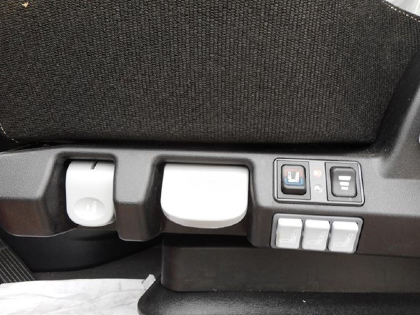 Cab view showing control panel and seat adjustment buttons in Freightliner Cascadia sleeper truck interior.
