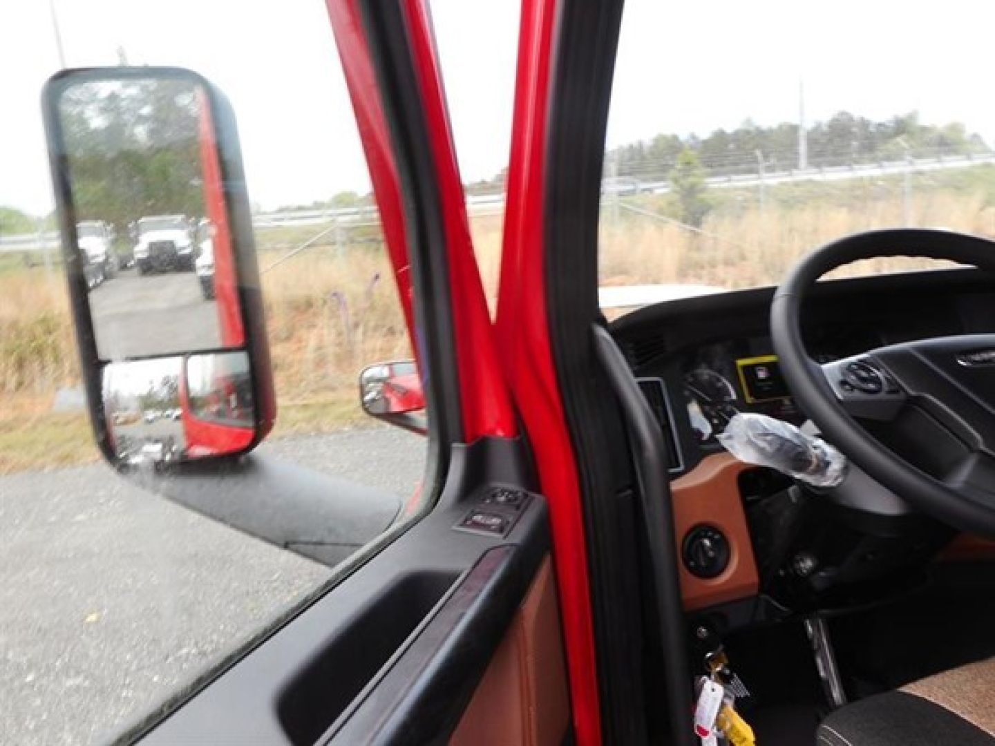 Cab interior of Freightliner Cascadia with steering wheel and dashboard visible