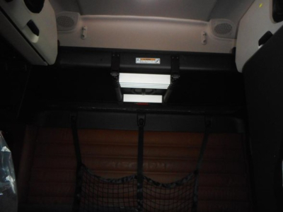Freightliner Cascadia 126 cab interior showing sleeper area with overhead console and cargo net. VIN: 3AKJHHDR4VSXE3912 visible on dash area.