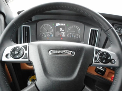 Interior of Freightliner Cascadia 126 steering wheel and dashboard with gauges and controls.