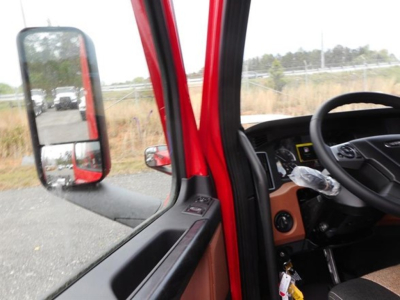 Cab interior of Freightliner Cascadia with steering wheel and dashboard visible