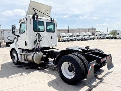 Truck chassis and cab of a 2020 Freightliner Cascadia126 in-service day cab, side rear view showing chassis, rear wheels, and absence of a complete trailer.