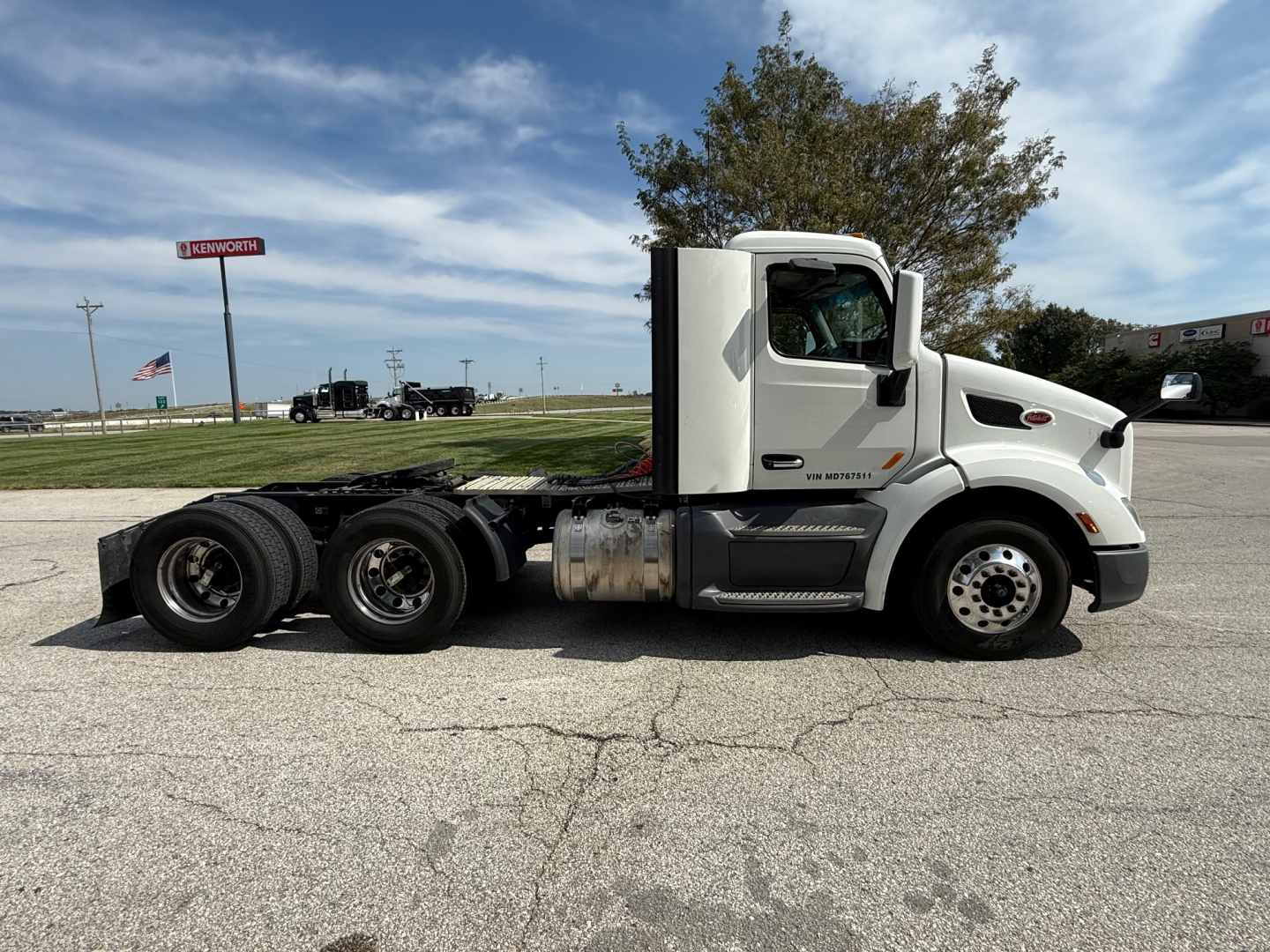 Peterbilt 579 conventional daycab tractor showing side profile with sleeper cab and dual rear axles.
