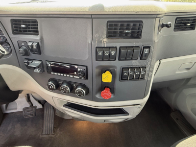 Peterbilt 579 cab interior dashboard area with controls, switches, and vents visible.