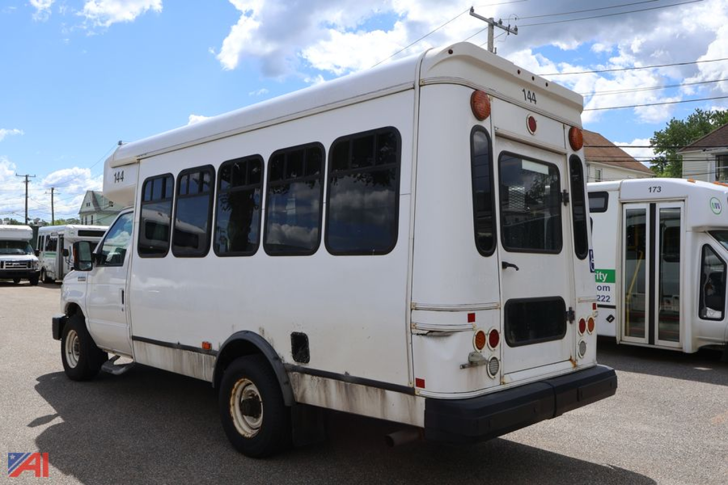 Ford E350 shuttle bus with wheelchair access rear door and rear view showing windows and side paneling