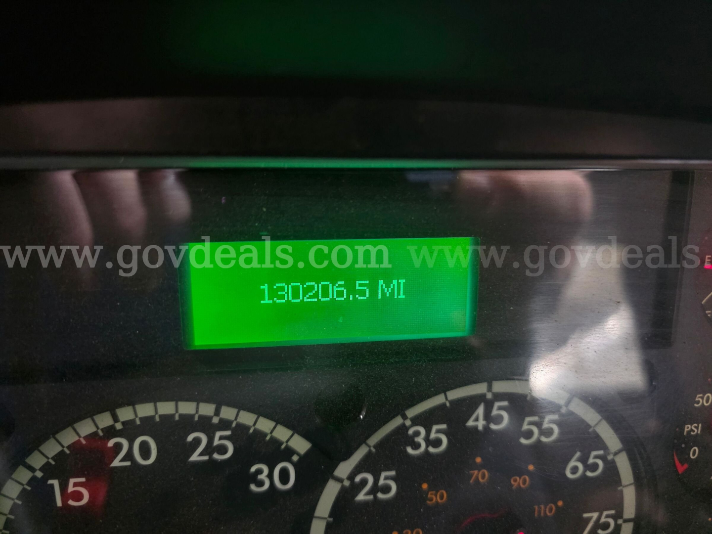 Display shows odometer reading 130206.5 miles; gauge cluster visible with numbers; green backlit diagnostic display panel in center