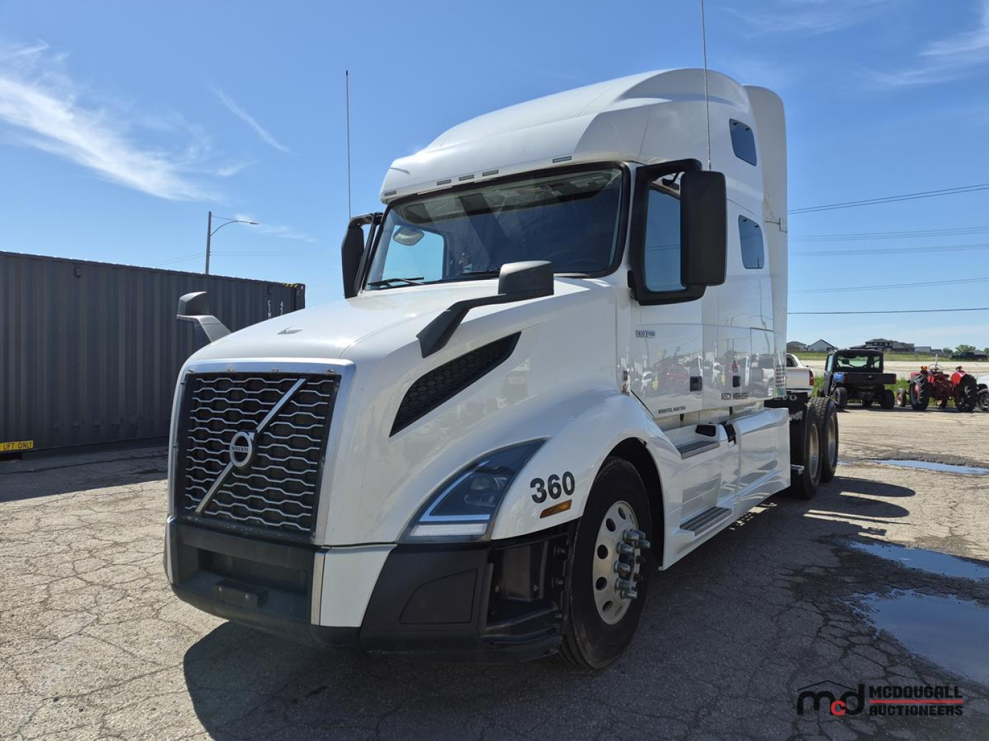 Volvo VNL760 day cab tractor showing 360 badge on front fender and aerodynamic grille with large side mirrors.