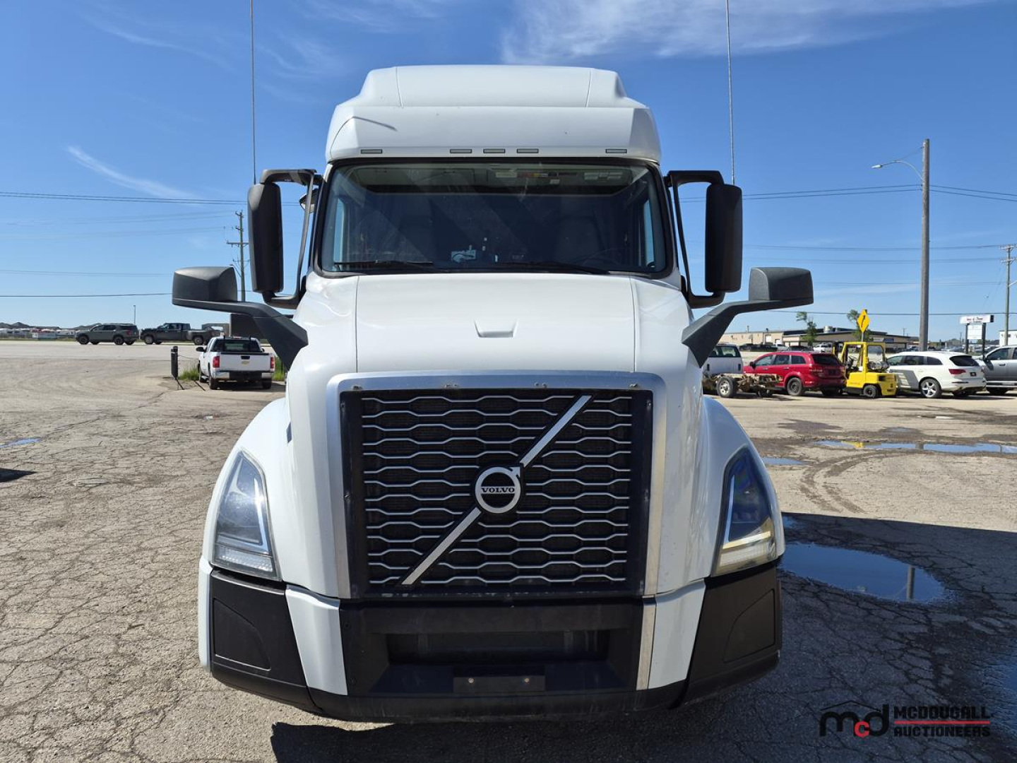 Volvo VNL760 day cab truck front view showing grille with diagonal Volvo badge and large bumper, white exterior.