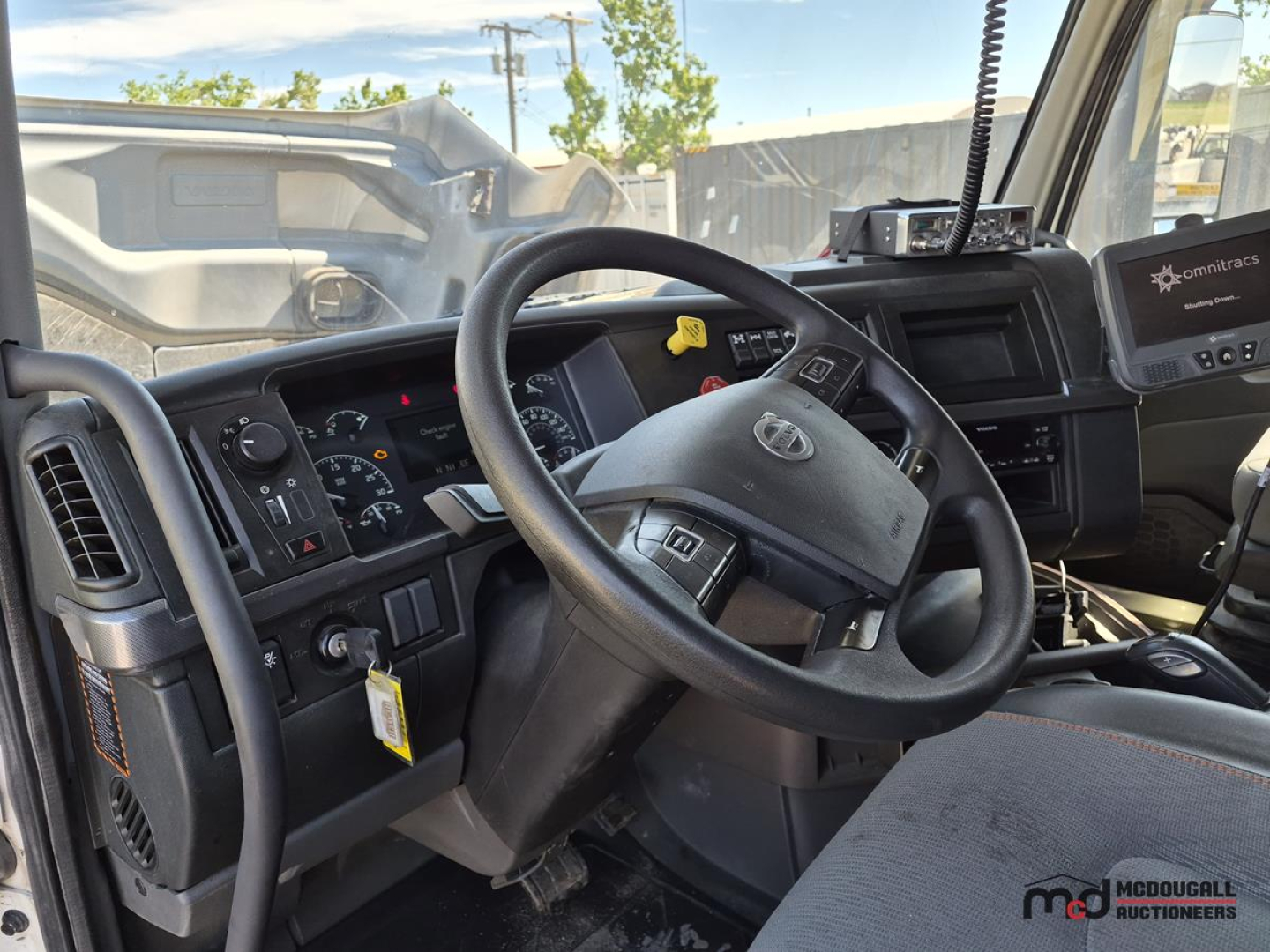 Volvo VNL interior cockpit showing steering wheel, dashboard gauges, and center console.