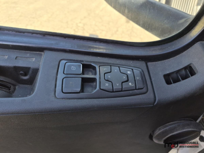 Dashboard controls in a Volvo VNL760 cab showing window/mirror switch cluster and directional pad.