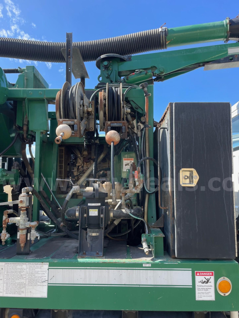 Freightliner vacuum truck rear section showing dual hose reels and hydraulic components