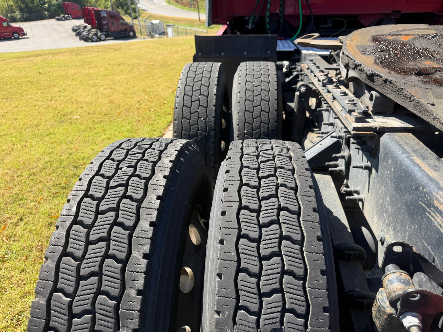 Volvo VNL64T760 truck chassis showing dual rear axles with dual tires and tire tread details.