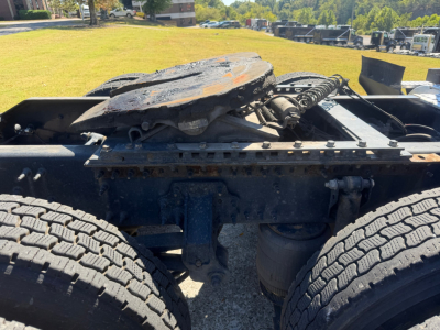 Volvo VNL64T760 truck chassis showing fifth wheel hitch and rear axle with dual tires and suspension components.
