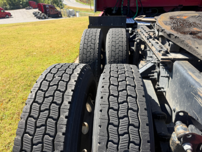 Volvo VNL64T760 truck chassis showing dual rear axles with dual tires and tire tread details.