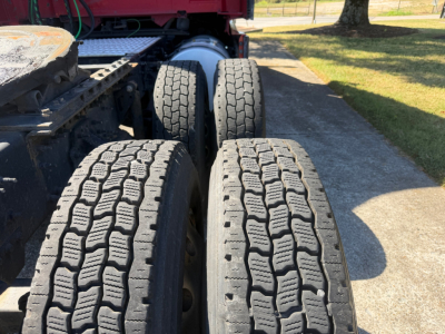 Volvo VNL64T760 truck rear showing dual rear axles with treaded tires and fifth wheel plate visible.