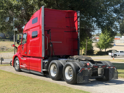  Volvo VNL64T760 sleeper tractor in red with rear view showing fifth wheel area and dual rear axles.
